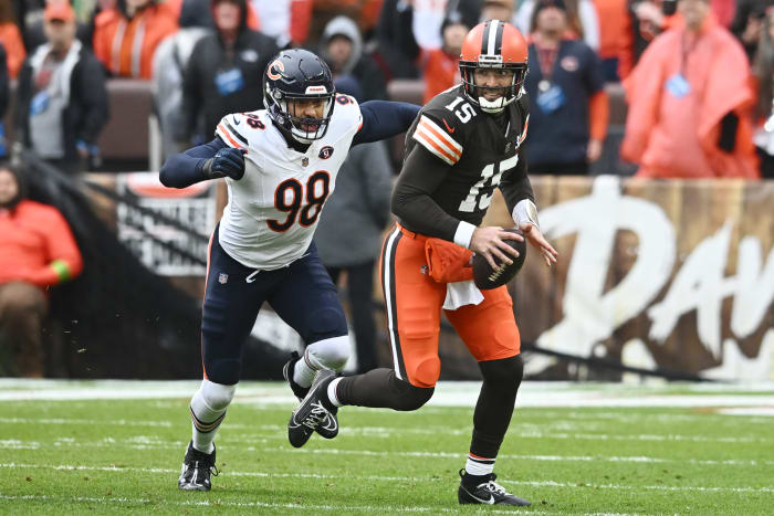 Montez Sweat reaches to tackle Joe Flacco, who runs with the ball